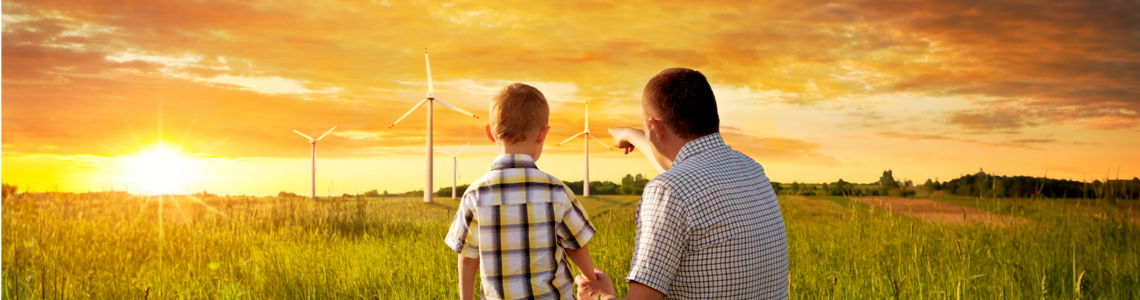 father and son watching wind mills